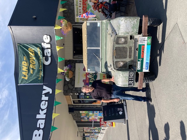 The 1948 Drive 4 Hearts Land Rover parked outside the Berry Barn with a Land Rover banner above the door